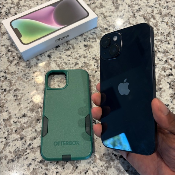 Apple iPhone 14 with green commuter Otterbox case